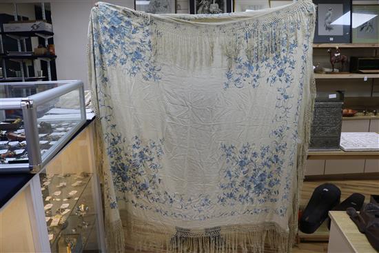 A Chinese embroidered shawl and another pale blue on cream embroidered shawl